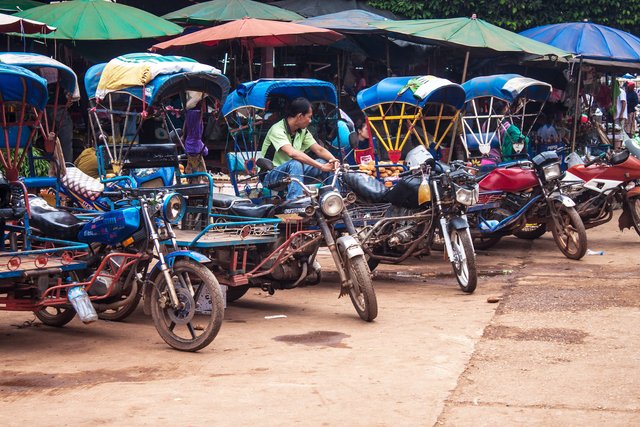 Tuk tuk drivers at a market in Pakse Laos